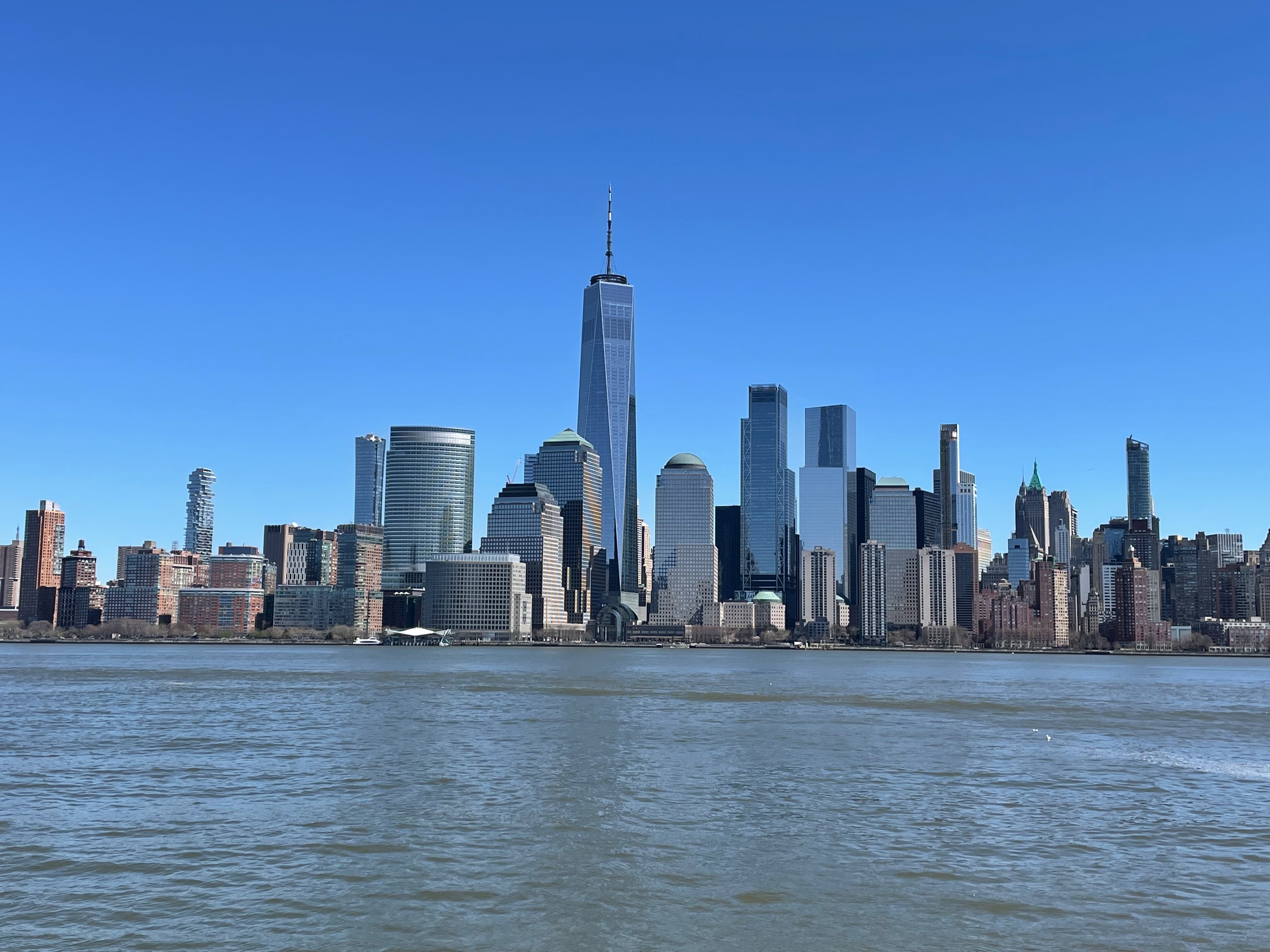 Manhattan skyline with skyscrapers and water in foreground